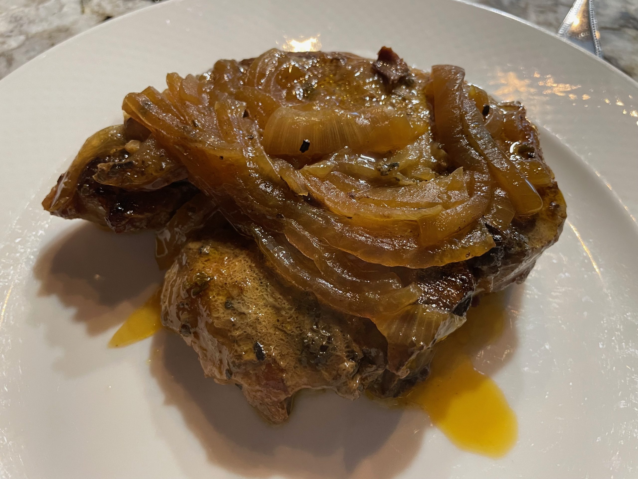 Slow-cooked pork chops with apples, onions, and sage in a crock pot