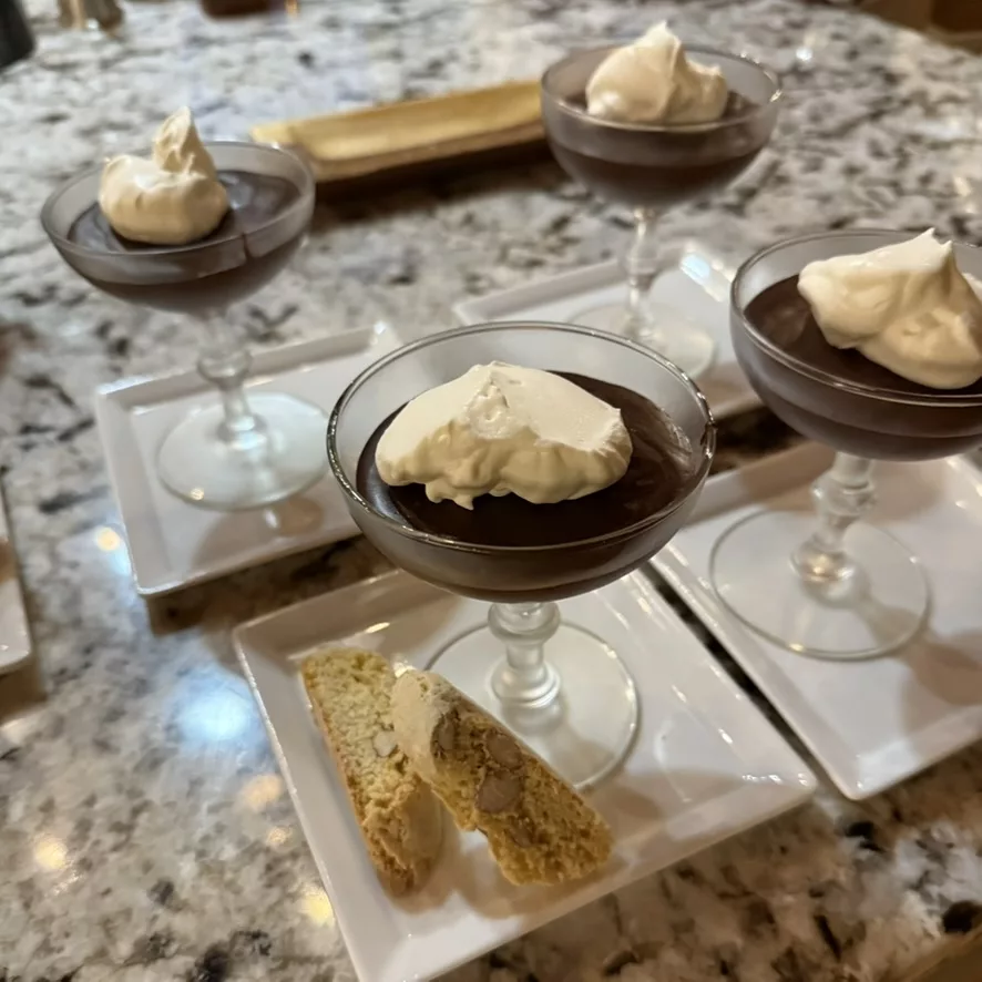 Chocolate pot de crème with whipped cream and almond biscotti
