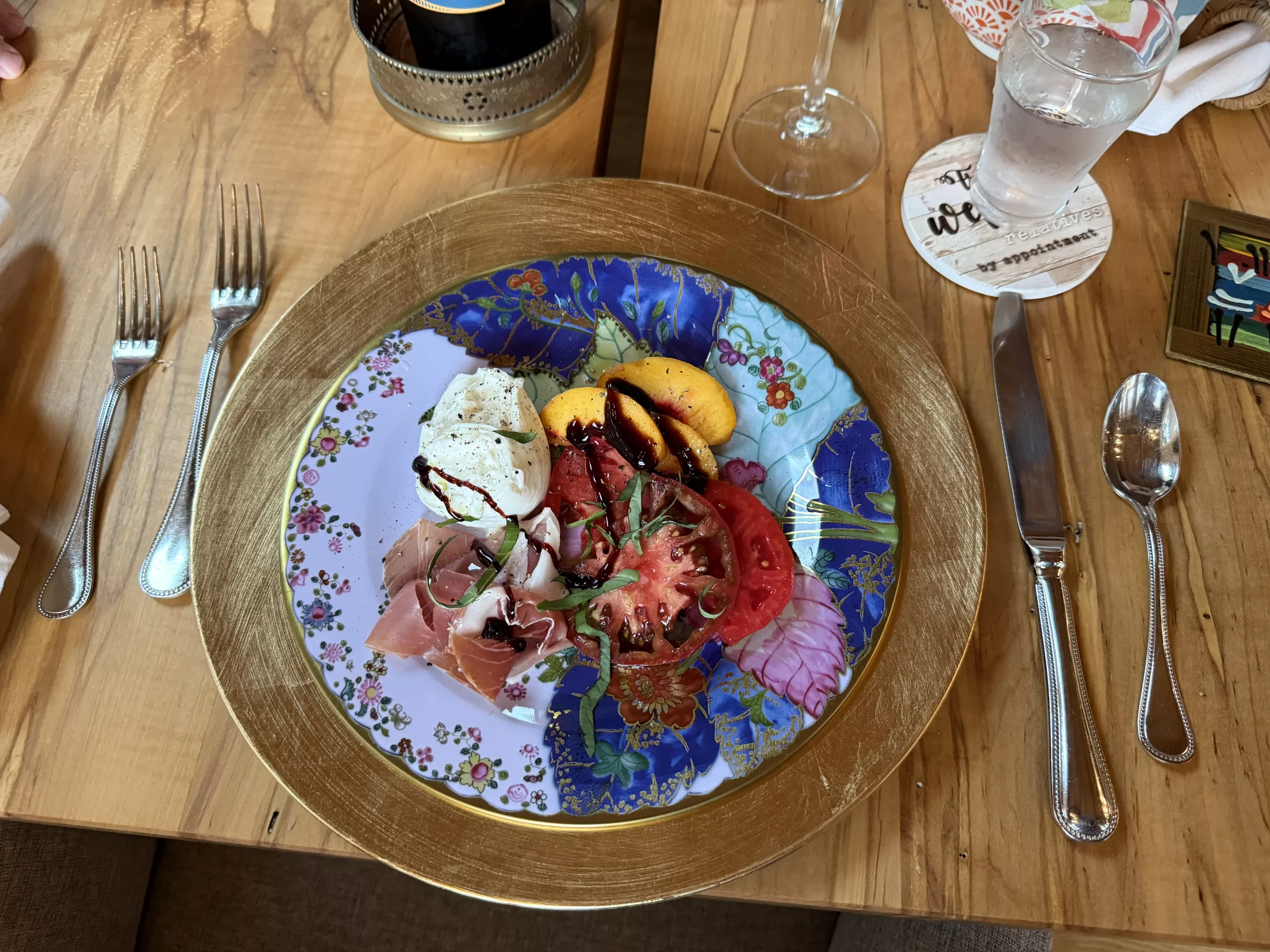 Peach and tomato salad with prosciutto, burrata and basil