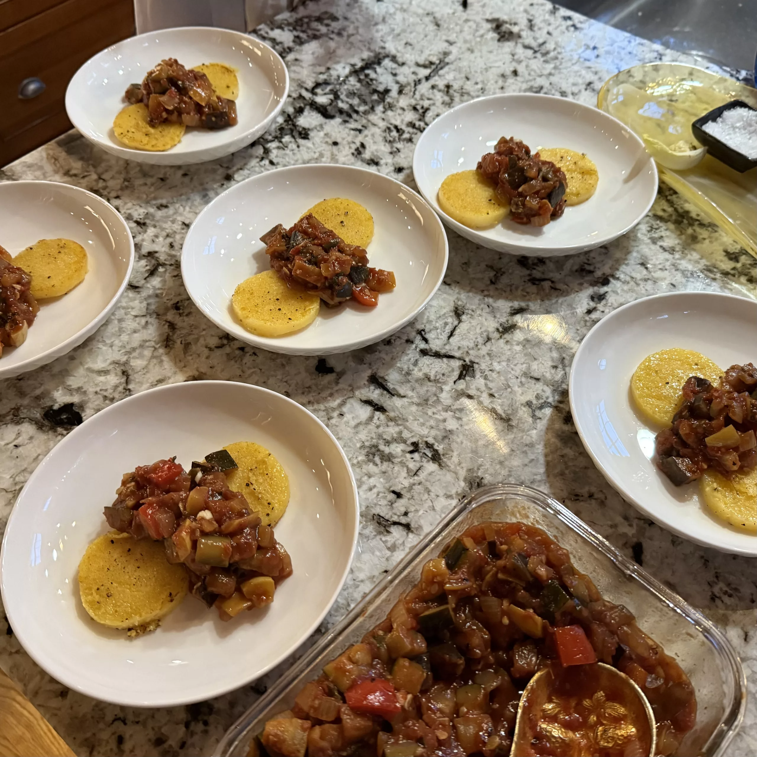 Crisped polenta cakes and a pan of ratatouille