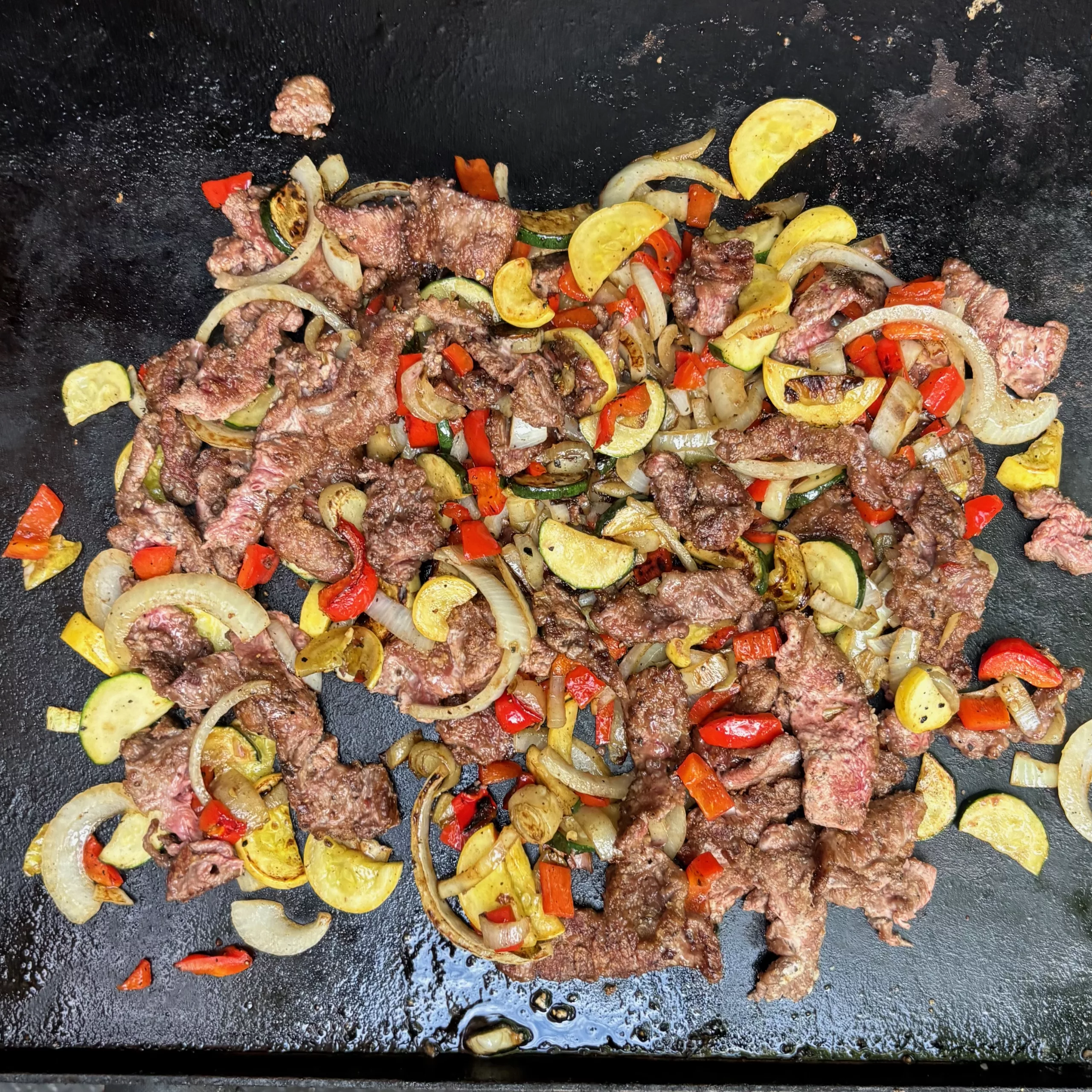 Thin slices of beef searing on a hot surface